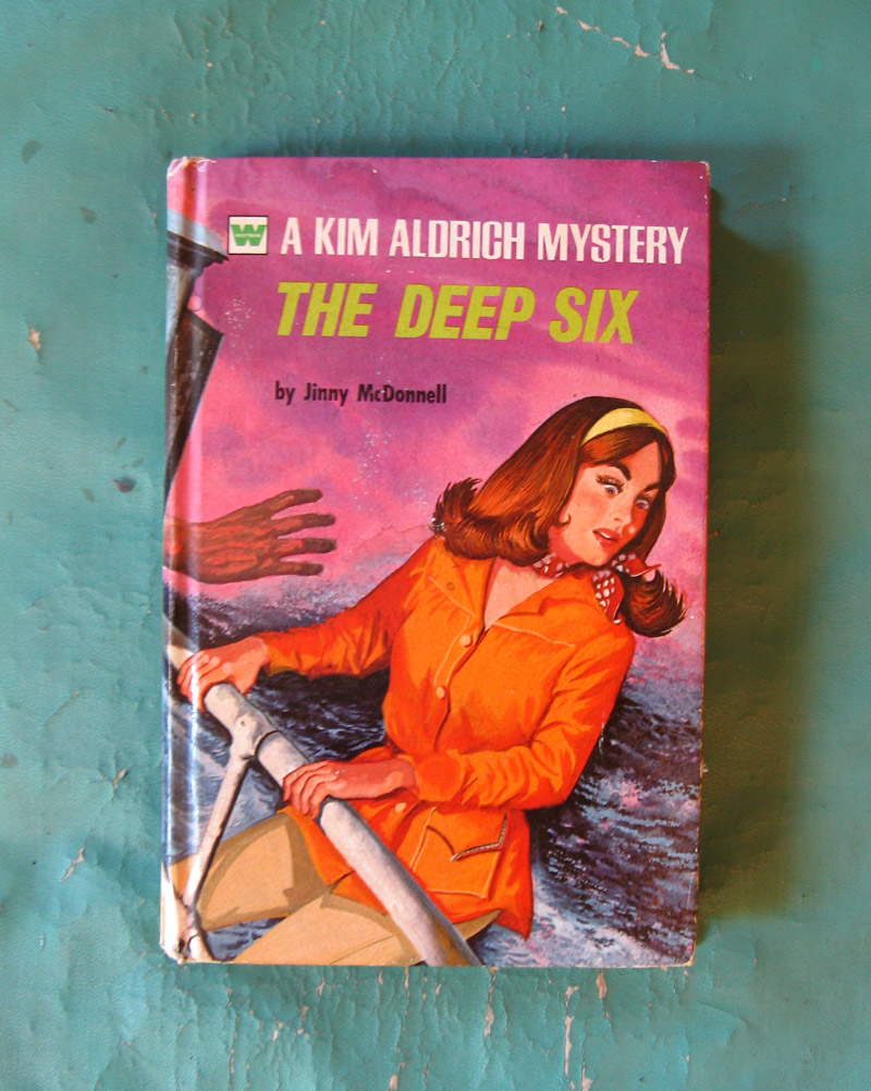 An old novel called the Deep Six with a creepy hand about to push a woman off a boat.