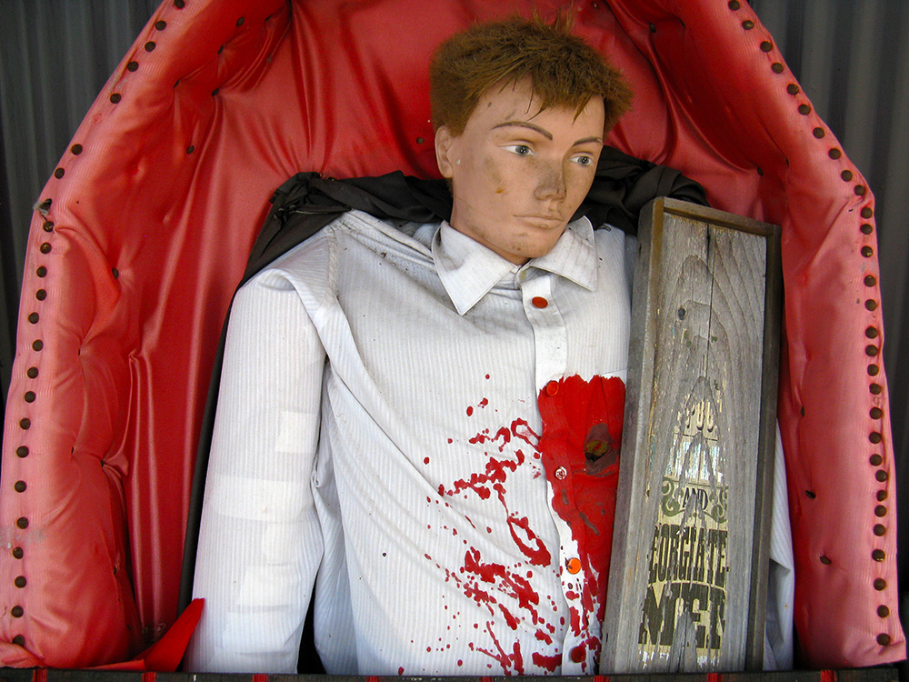 Bloody mannequin in a coffin.