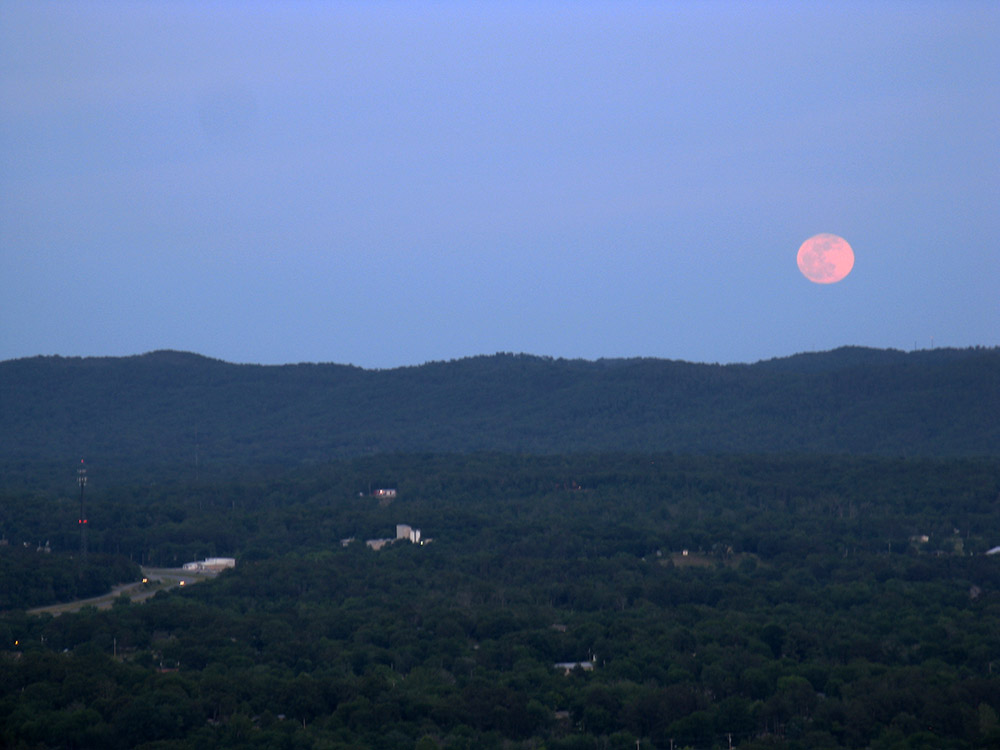 A very pink moon in a very blue evening.