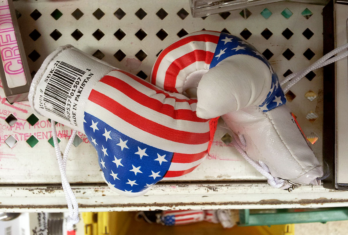 Tiny boxing gloves with a flag printed on them and a giant barcode and text that reads, Made in Pakistan.