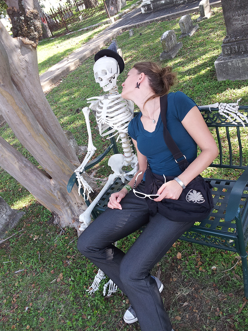 Me on a bench with a skeleton.