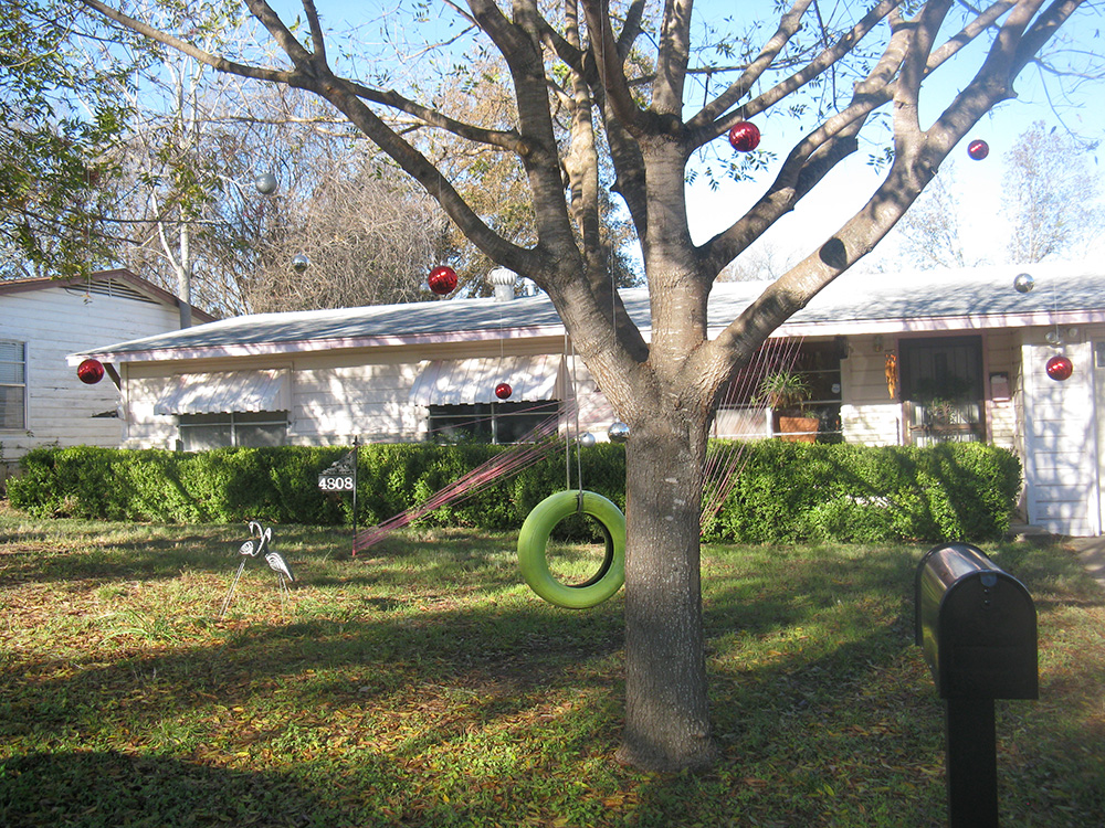 Ornaments hanging from our trees in the front yard.