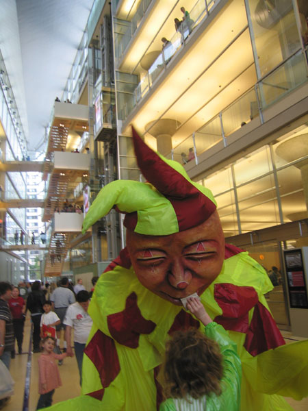 Jester with puppet head inside library