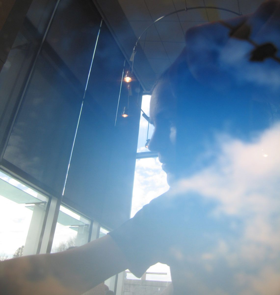 Meg reflected in her laptop with clouds