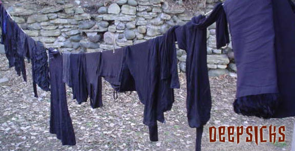 Laundry hanging on the line, all of it is black.