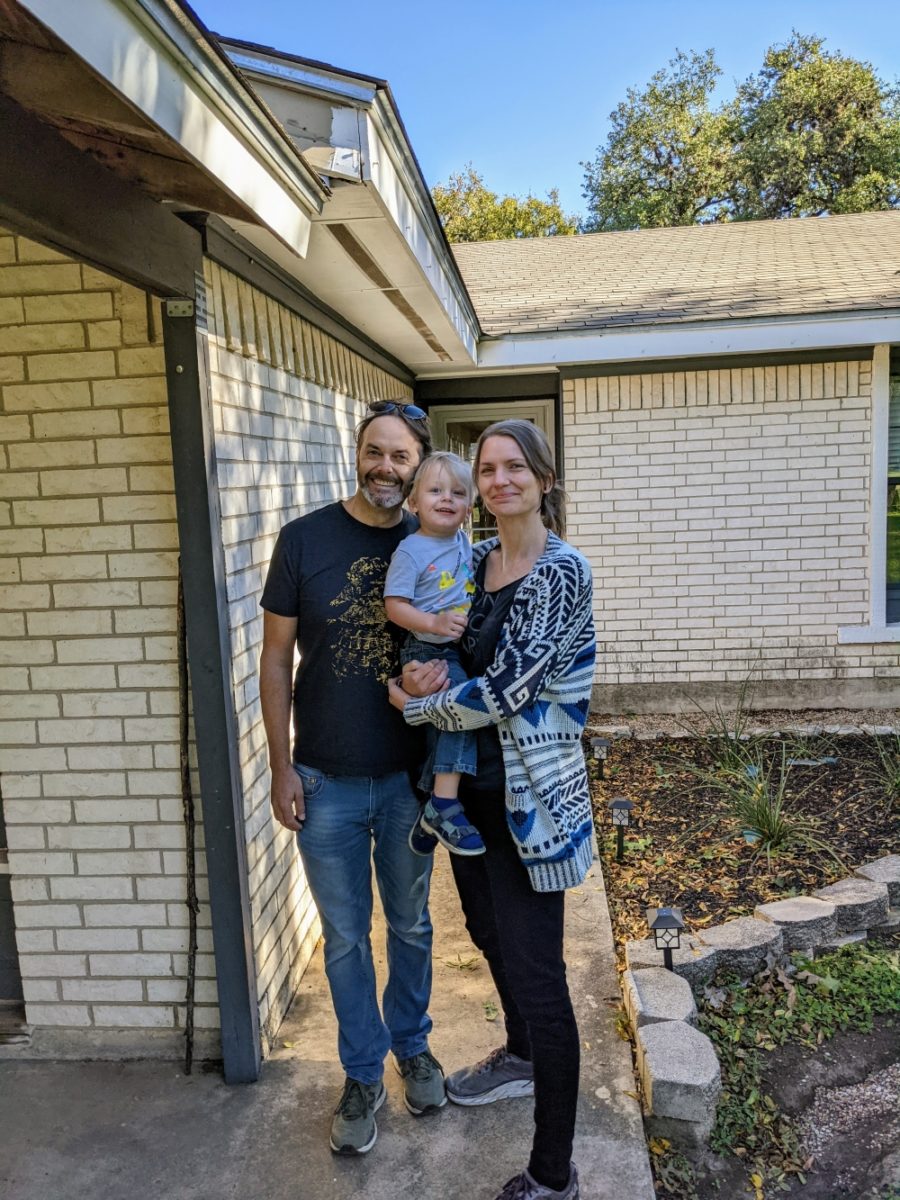 Photo of Meg, Arthur and Louie in front of a house.