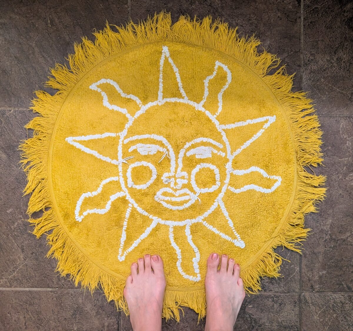A yellow rug that looks like a sun.