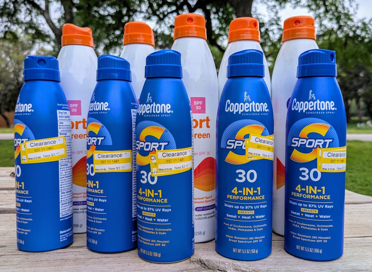 10 bottles of sunscreen, some with clearance labels.